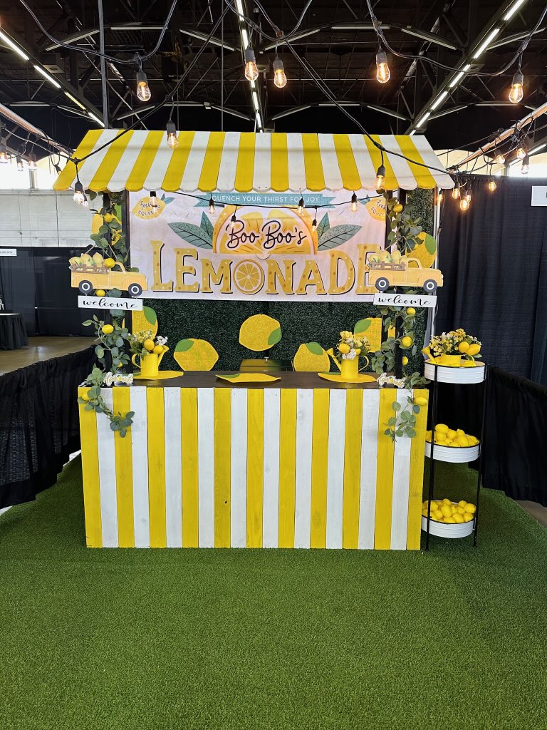 Indoor branded Boo Boo's Lemonade stand with Quench Your Thirst For Joy banner